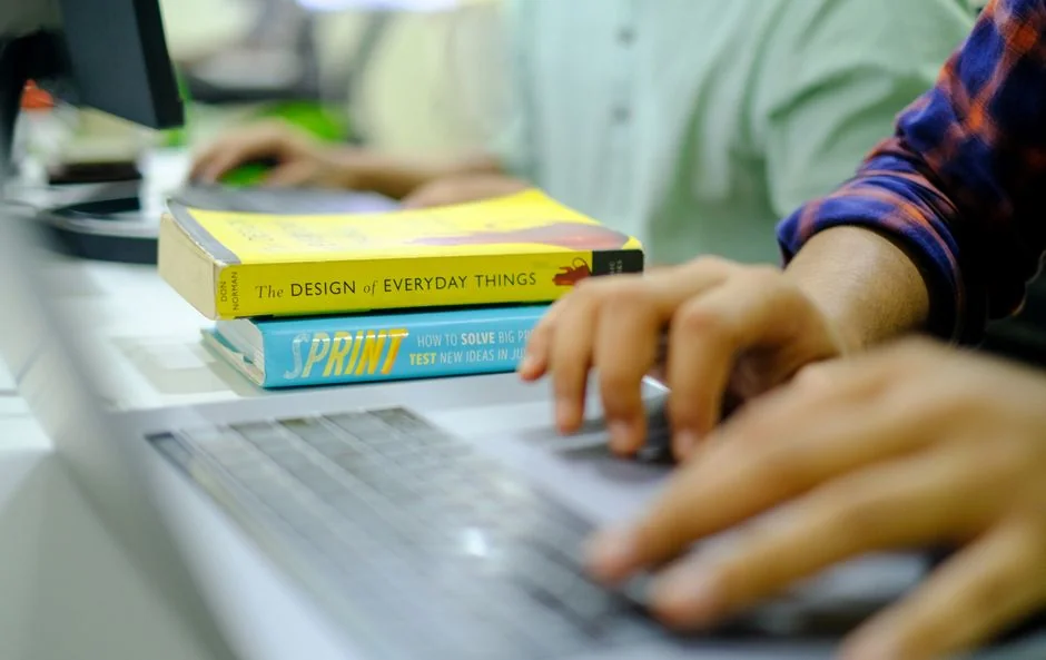 about-01 A focused designer works on a user-centric project in a modern office environment.